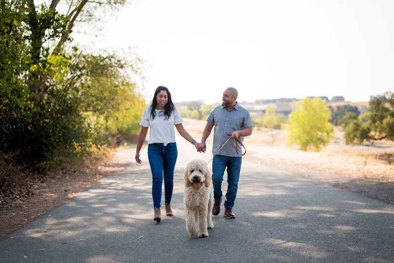 candid outdoor couple portrait photo with dog