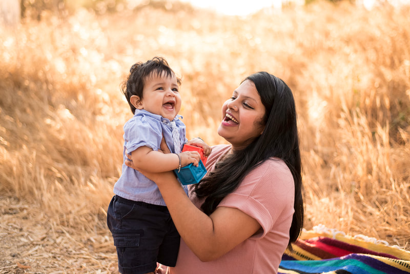 candid outdoor mom and baby family portrait photo at Putah Creek in Davis